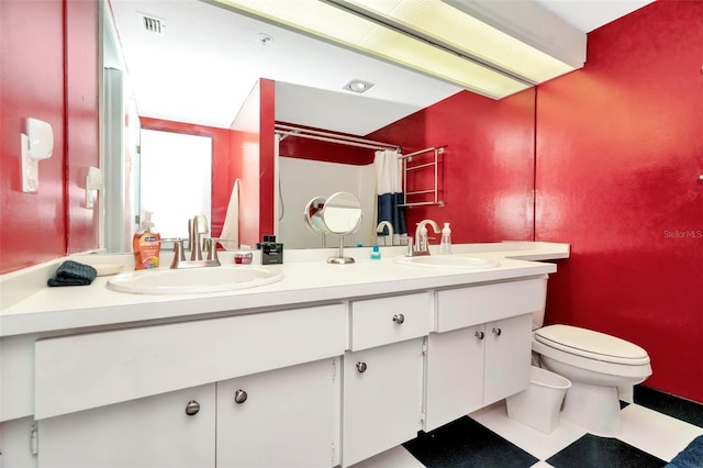 bathroom featuring curtained shower, vanity, and toilet