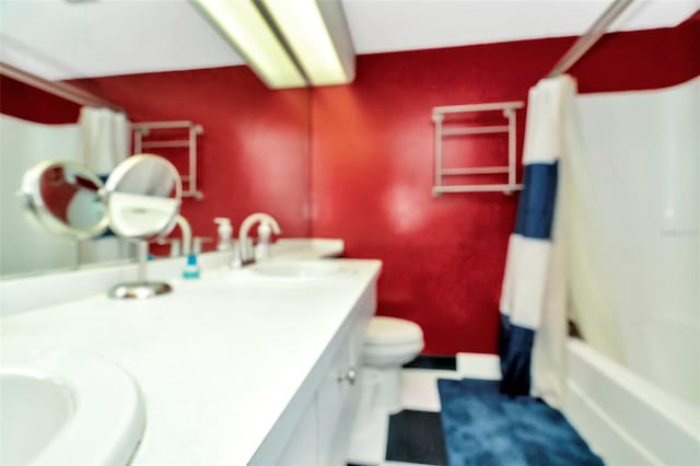 full bathroom with vanity, toilet, and shower / bath combo with shower curtain