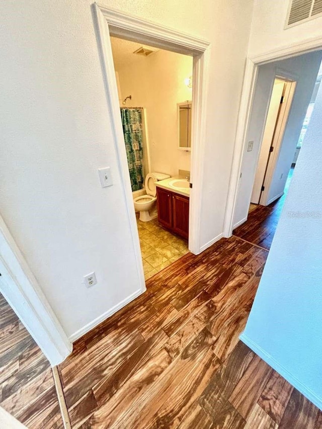 hall with sink and dark hardwood / wood-style floors