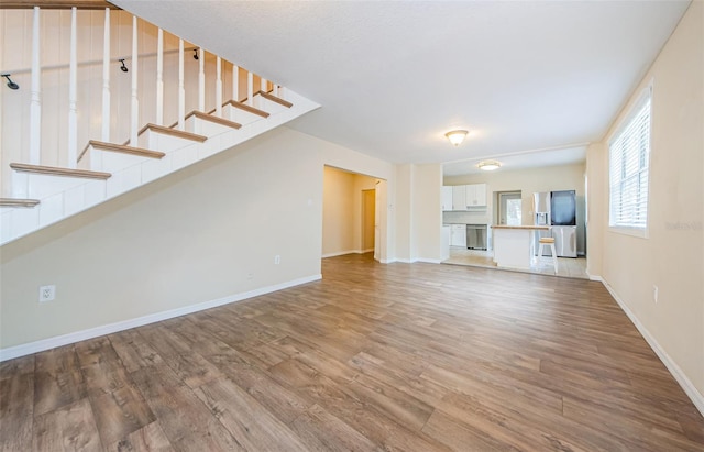 unfurnished living room featuring wood-type flooring