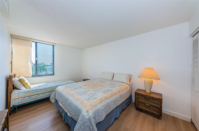 bedroom featuring light hardwood / wood-style floors and a closet