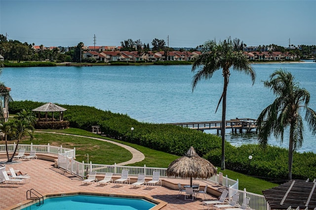 view of swimming pool featuring a gazebo, a patio area, a lawn, and a water view