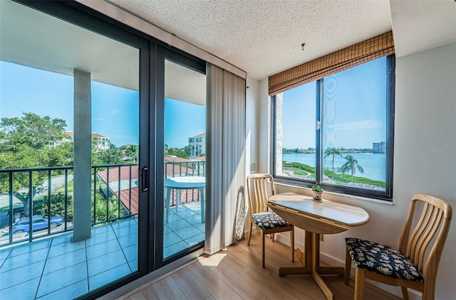 sunroom / solarium with a water view