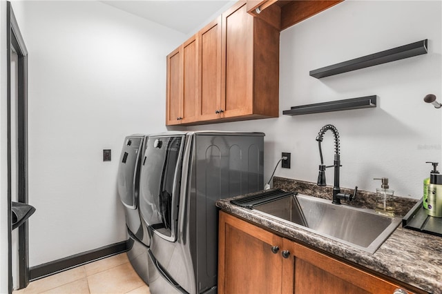 washroom featuring washer and dryer, light tile patterned floors, cabinets, and sink