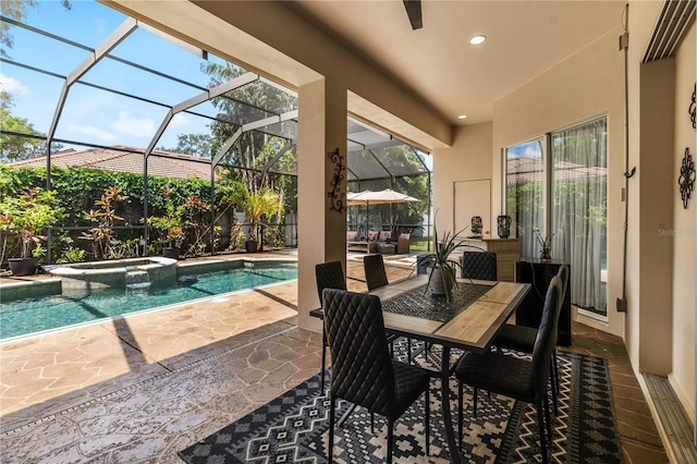 view of pool with a lanai, an in ground hot tub, and a patio