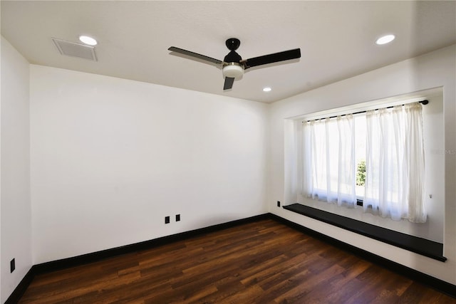 spare room with ceiling fan and dark hardwood / wood-style flooring