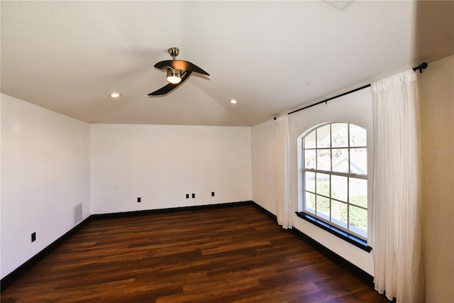 unfurnished room with lofted ceiling, dark hardwood / wood-style flooring, and ceiling fan