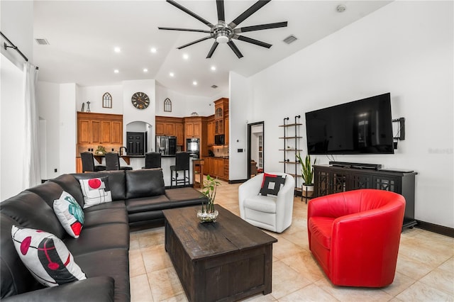 living room featuring ceiling fan, high vaulted ceiling, and light tile patterned floors