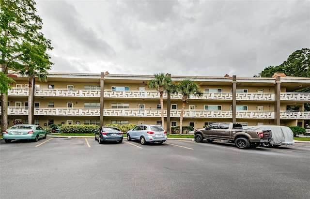 view of building exterior featuring uncovered parking