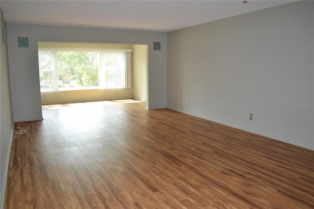 spare room featuring wood finished floors