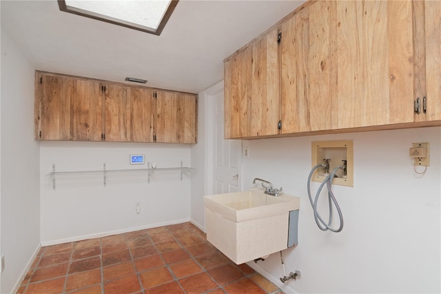 clothes washing area featuring cabinets, sink, and hookup for a washing machine