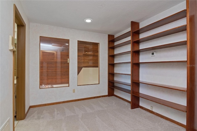 carpeted spare room featuring a textured ceiling