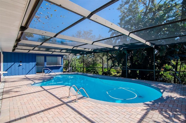 view of swimming pool featuring a lanai and a patio