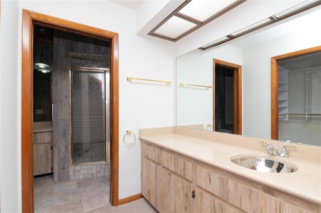 bathroom with walk in shower and vanity