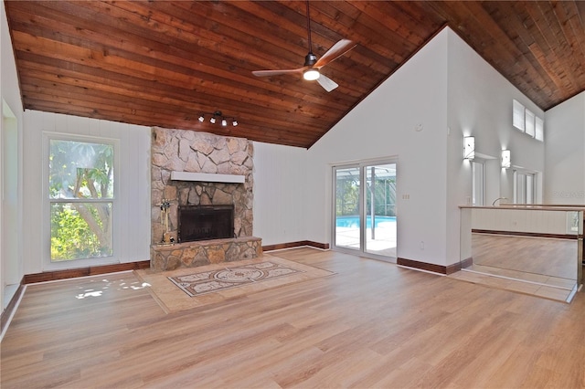 unfurnished living room with ceiling fan, a fireplace, light hardwood / wood-style floors, high vaulted ceiling, and wooden ceiling