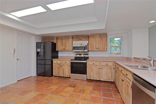 kitchen featuring sink, appliances with stainless steel finishes, a raised ceiling, and light tile patterned flooring