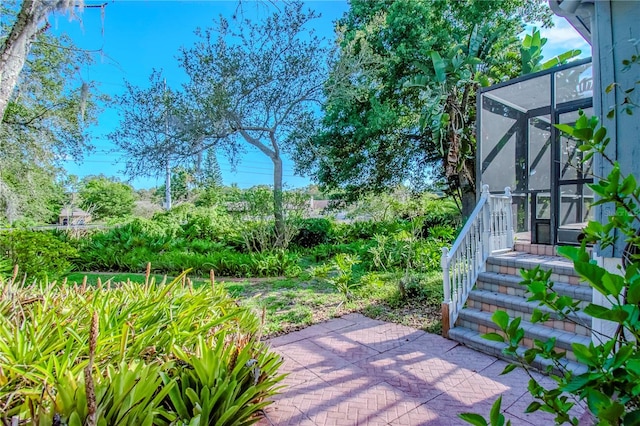 view of patio featuring a lanai