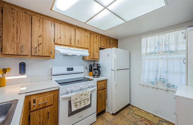 kitchen with white appliances and light tile patterned floors