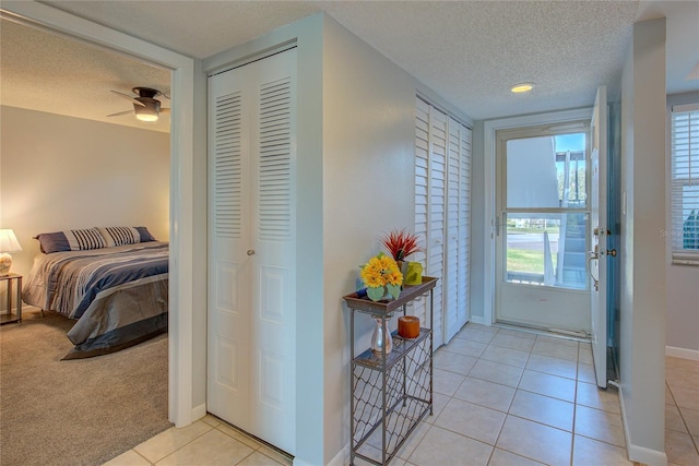 interior space with light tile patterned floors and a textured ceiling