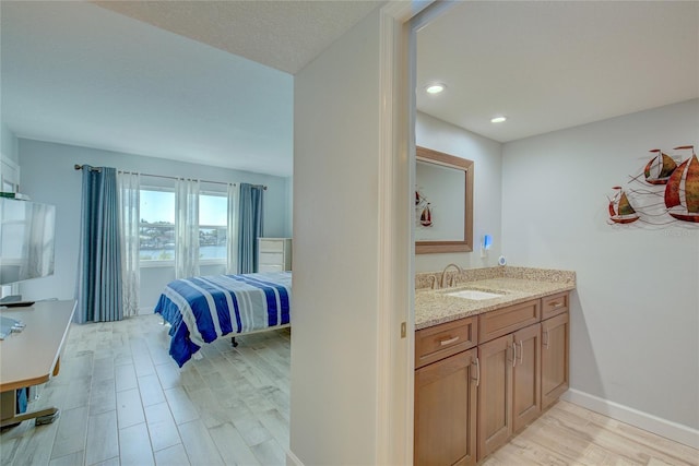 bathroom with vanity and hardwood / wood-style flooring