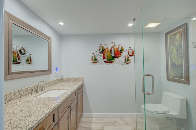 bathroom featuring an enclosed shower, vanity, toilet, and wood-type flooring