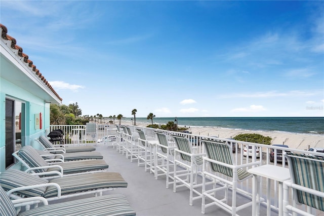 view of patio featuring a view of the beach and a water view