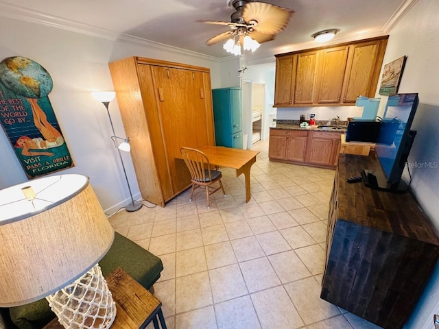 kitchen with ceiling fan, light tile flooring, sink, and ornamental molding