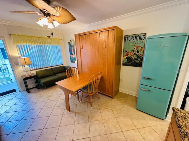 tiled dining space featuring ornamental molding and ceiling fan