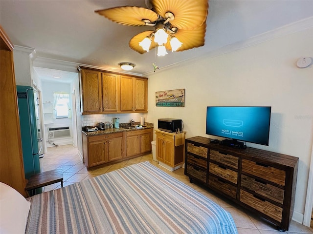 kitchen featuring crown molding, backsplash, ceiling fan, and light tile floors