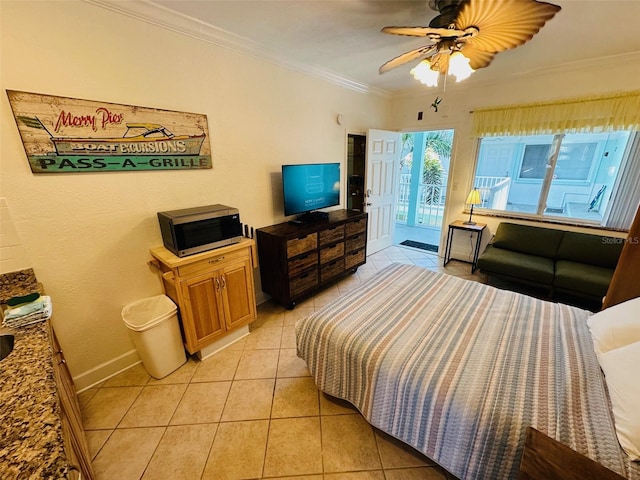 tiled bedroom with ornamental molding and ceiling fan