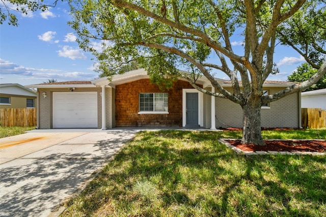 ranch-style home featuring a front yard and a garage