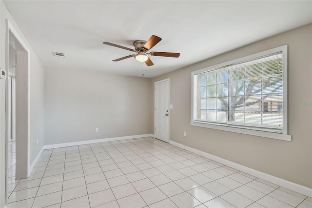 tiled empty room with ceiling fan