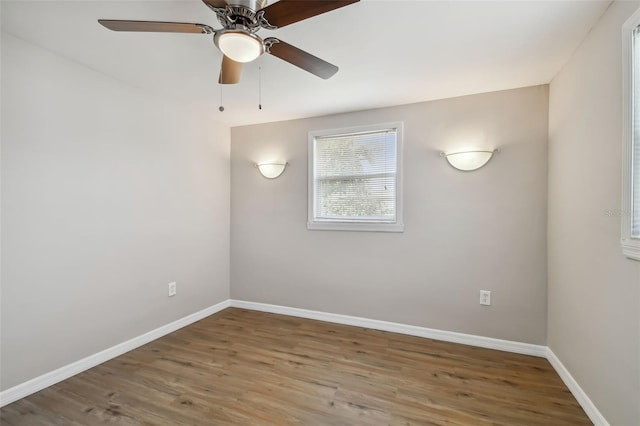 spare room with ceiling fan and hardwood / wood-style flooring