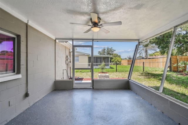 unfurnished sunroom featuring ceiling fan