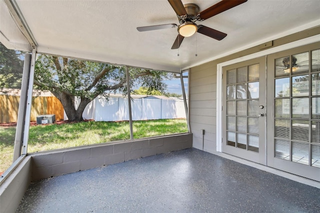 unfurnished sunroom featuring a wealth of natural light and ceiling fan