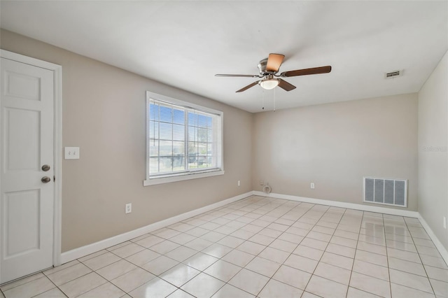 tiled spare room featuring ceiling fan