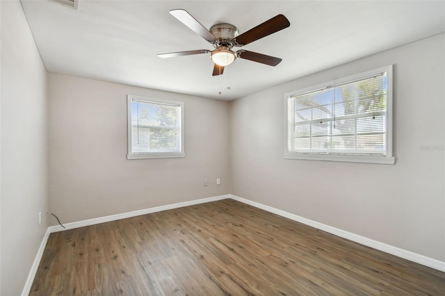 unfurnished room with dark hardwood / wood-style flooring and ceiling fan