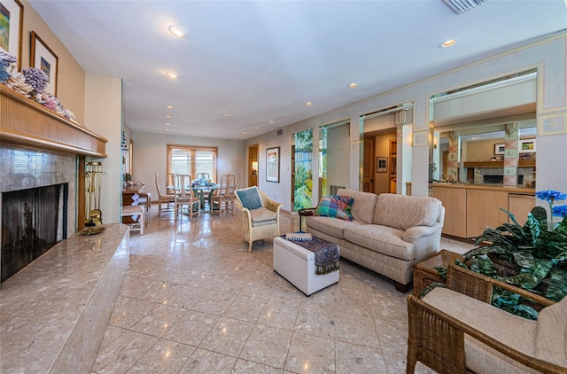 living room featuring a fireplace and light tile floors