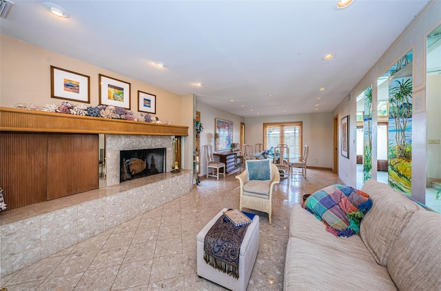 living room with tile floors and a fireplace