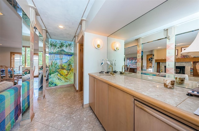 kitchen featuring light tile floors, sink, and tile countertops