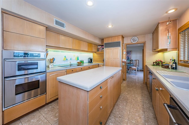 kitchen featuring appliances with stainless steel finishes, tasteful backsplash, light tile floors, and a kitchen island with sink