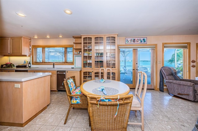 tiled dining room with sink and french doors