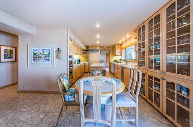 tiled dining room featuring sink