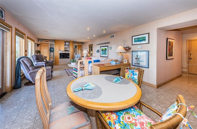 dining area featuring light tile floors