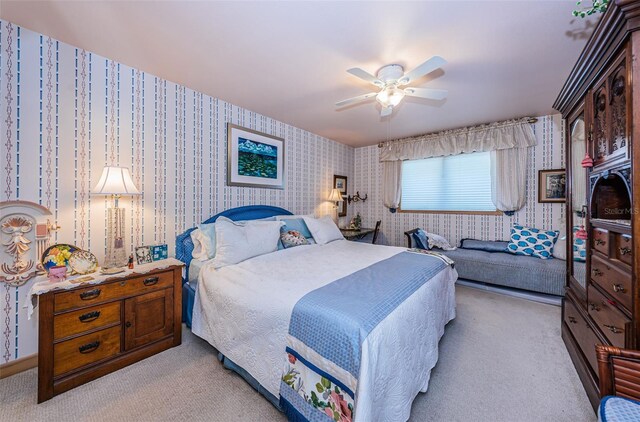 bedroom with ceiling fan and light colored carpet