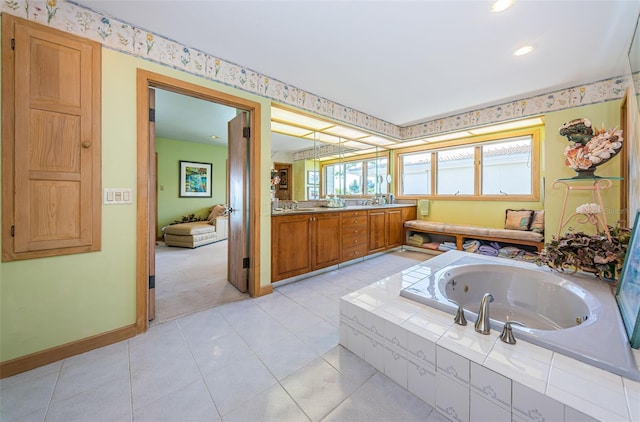 bathroom featuring tiled bath, vanity, and tile floors