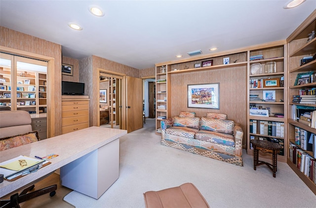 home office with light colored carpet and built in shelves