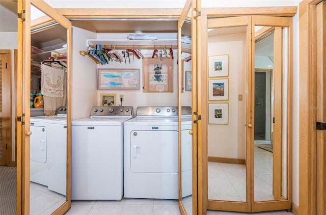 clothes washing area with independent washer and dryer, light tile floors, and hookup for a washing machine