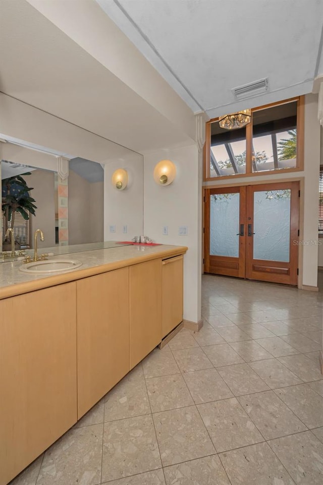 interior space featuring light countertops, french doors, a sink, and visible vents