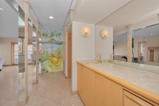 bathroom with recessed lighting, baseboards, and vanity